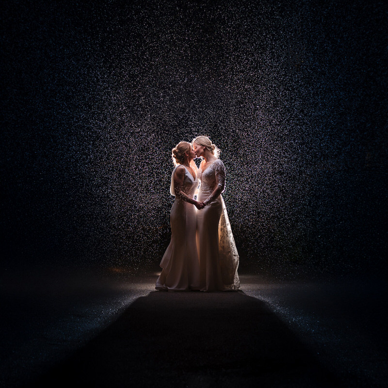 Lesbian wedding rain backlit portrait at Lodore Falls