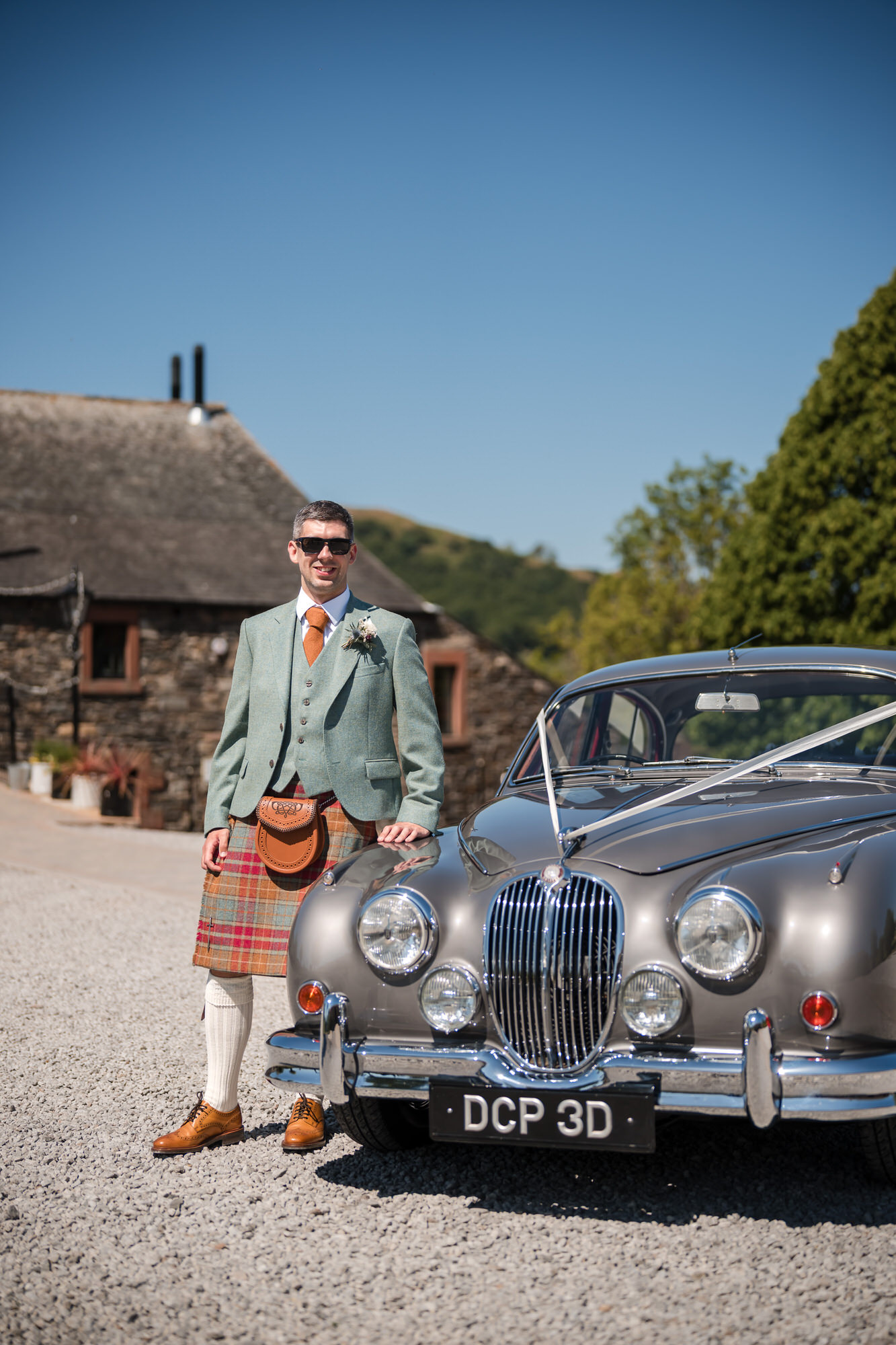 Groom portrait with a vintage car at New House Farm