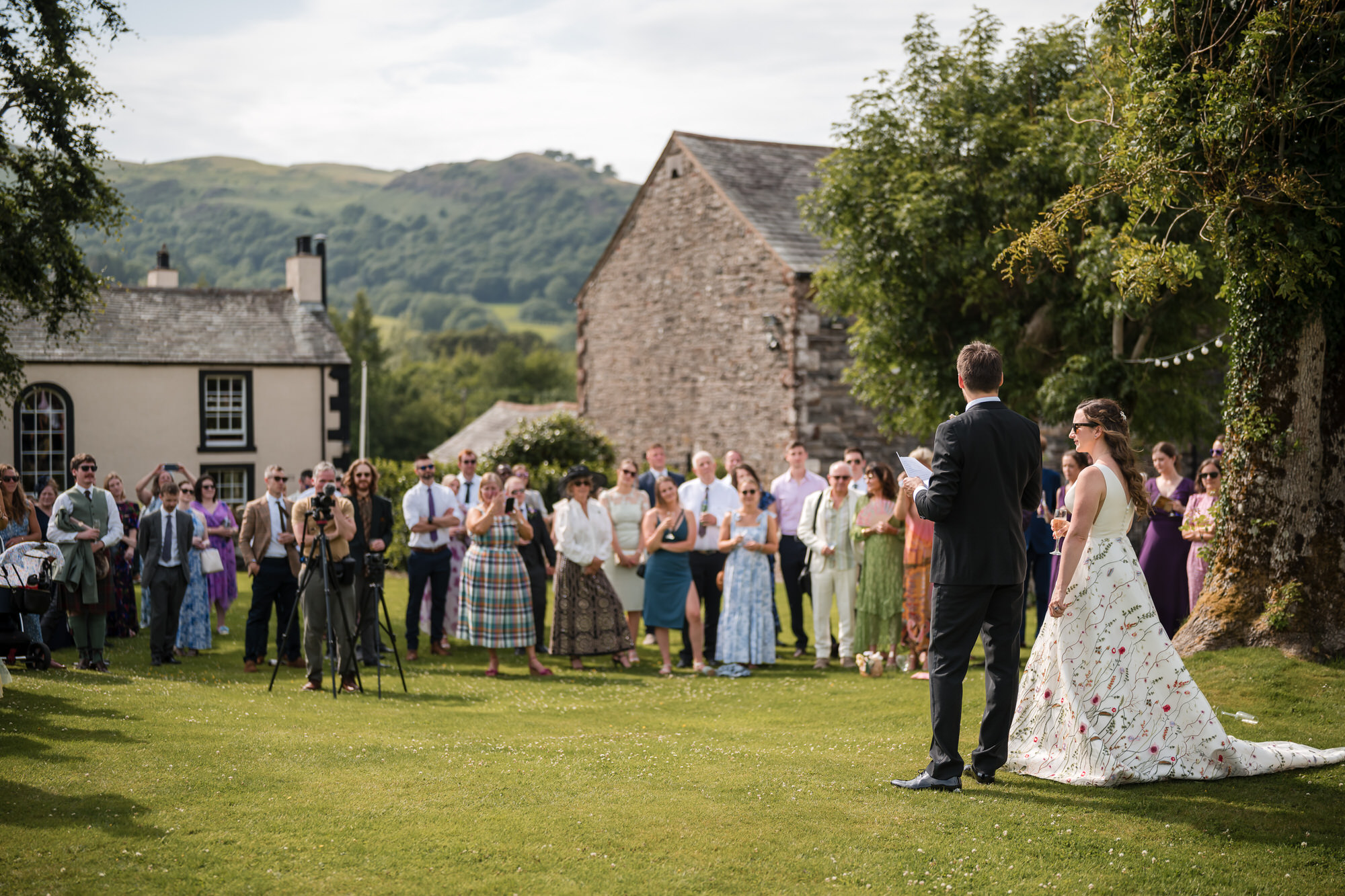 Outdoor wedding speeches at New House Farm in the Lorton Valley
