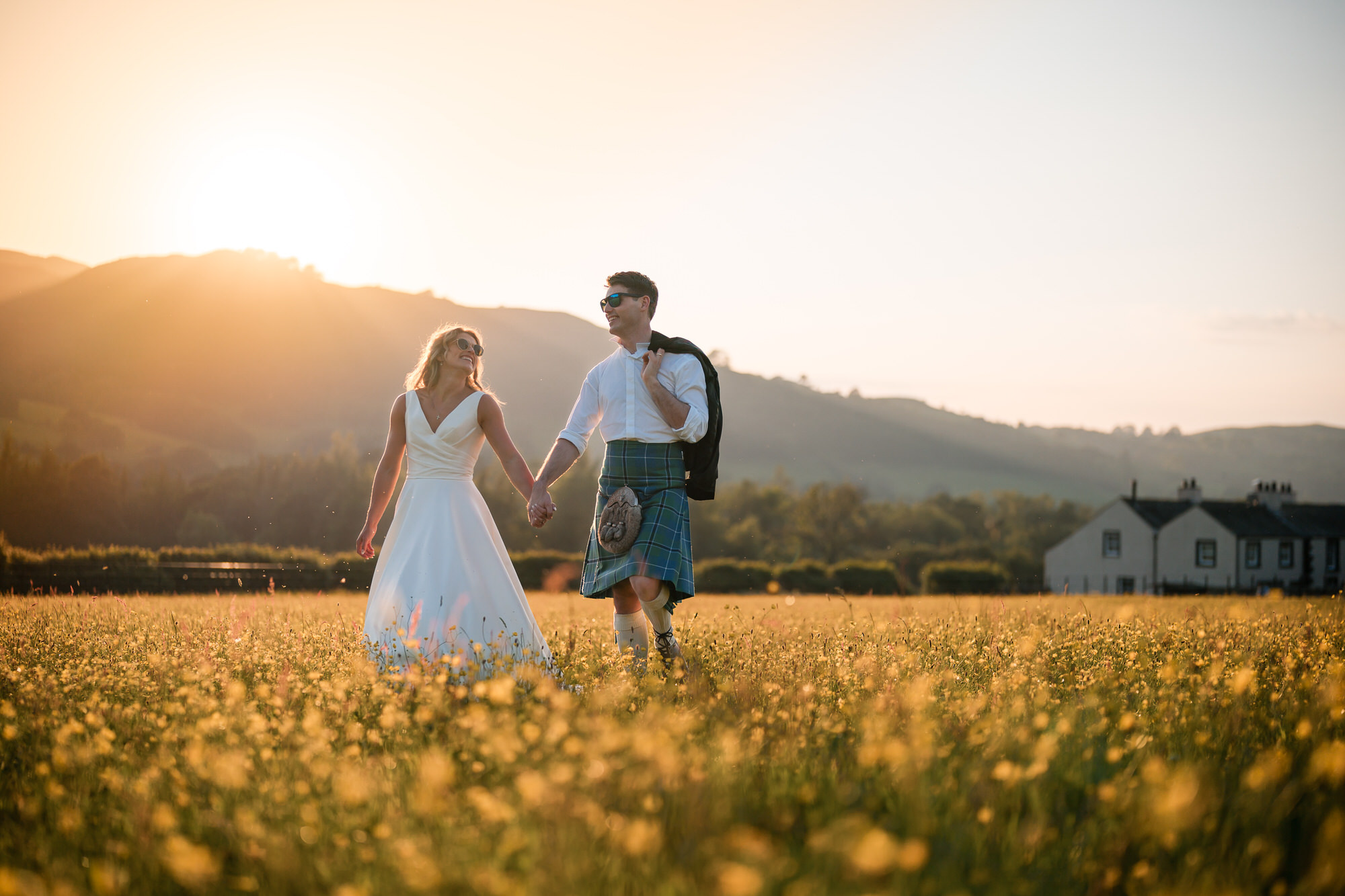 Golden hour wedding couple portraits in a meadow at New House Farm
