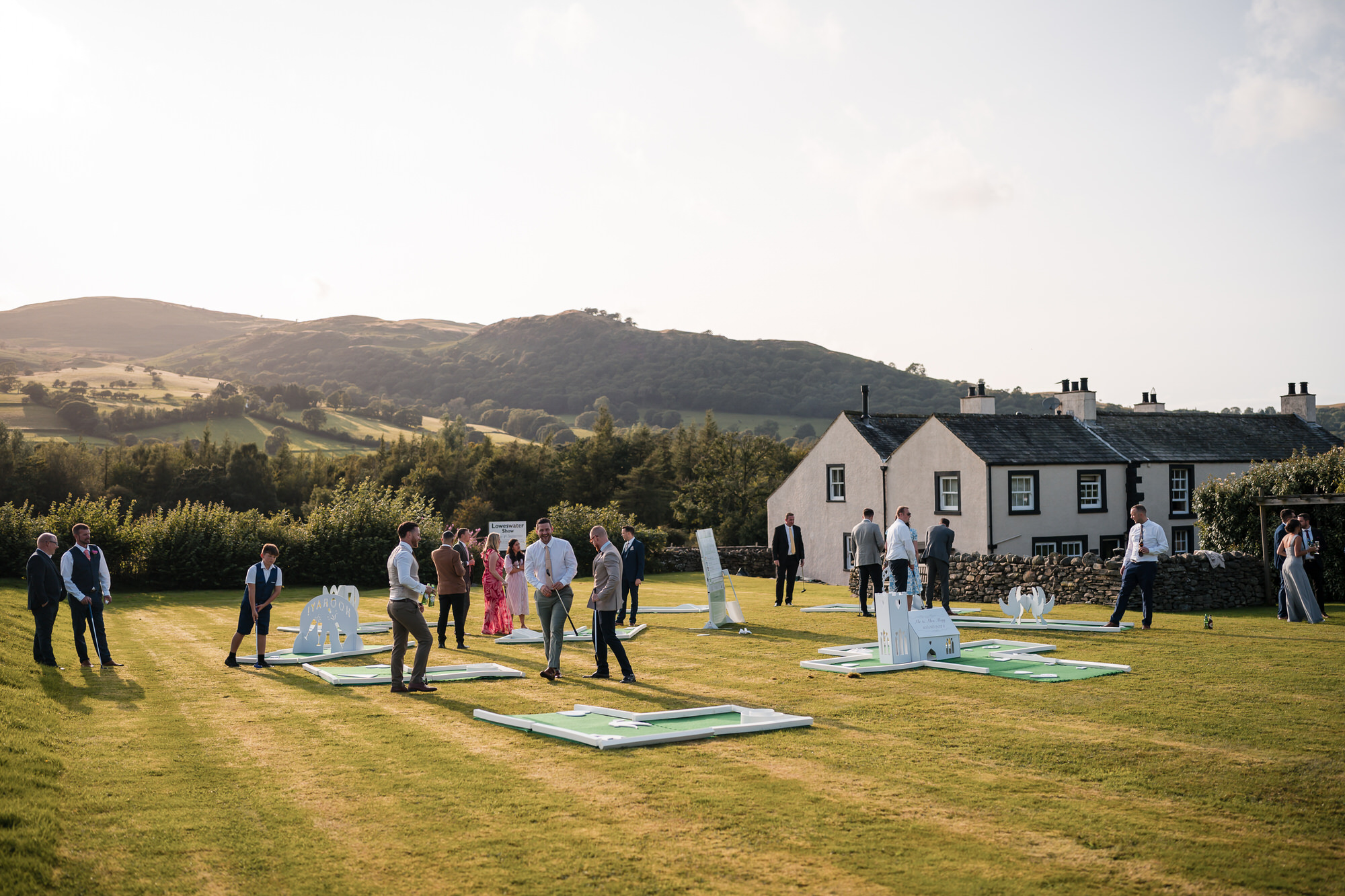 Wedding party enjoying lawn games at New House Farm in the evening