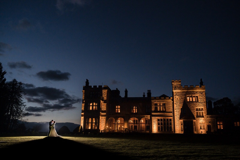 Wide evening portrait at Armathwaite Hall with the building illuminated at night