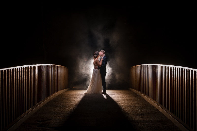 Dramatic night wedding portrait on bridge at Lodore Falls with backlight and atmosphere