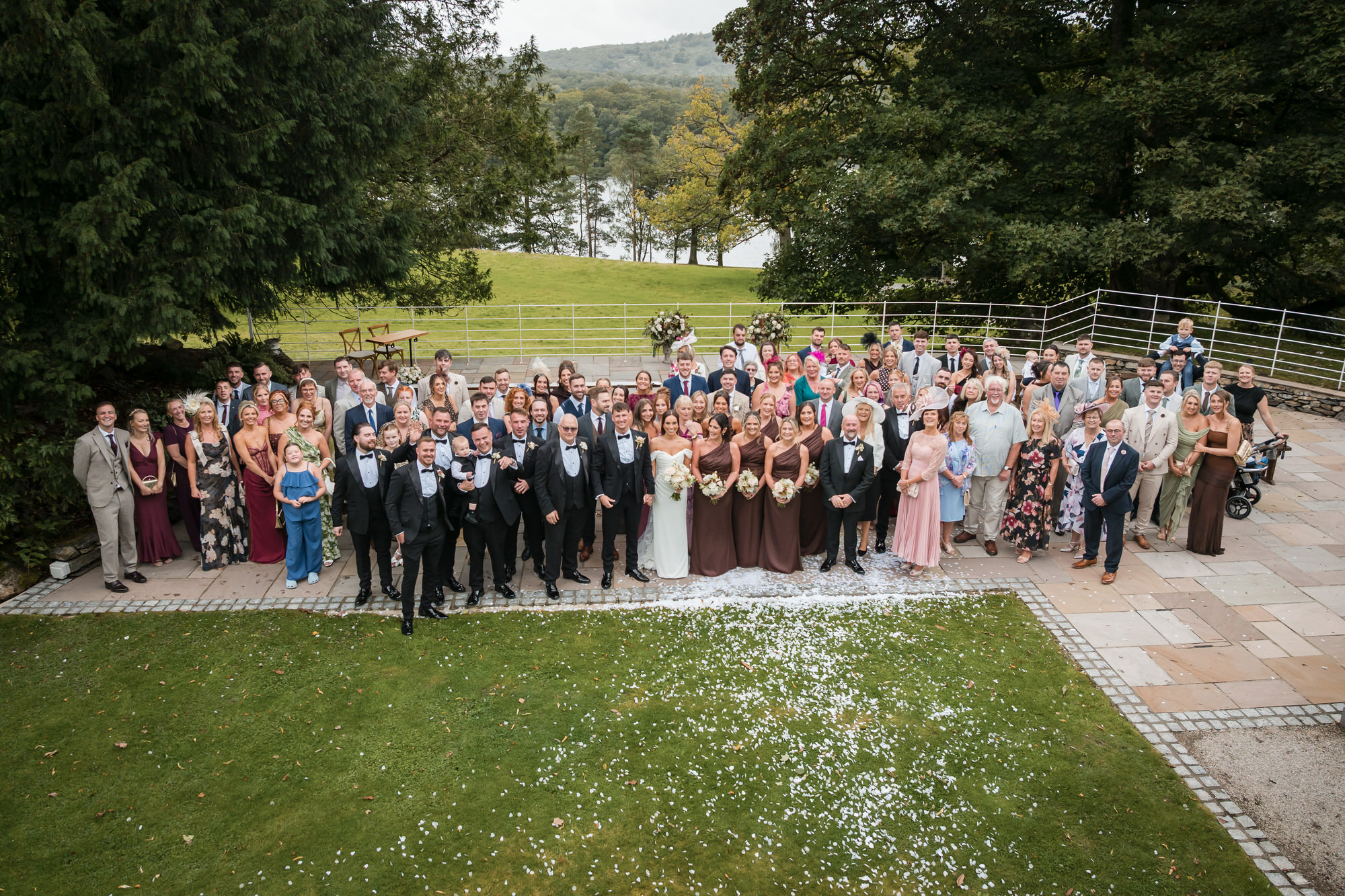 Dan and Ellie with their wedding guests gathered outside Town Head Estate
