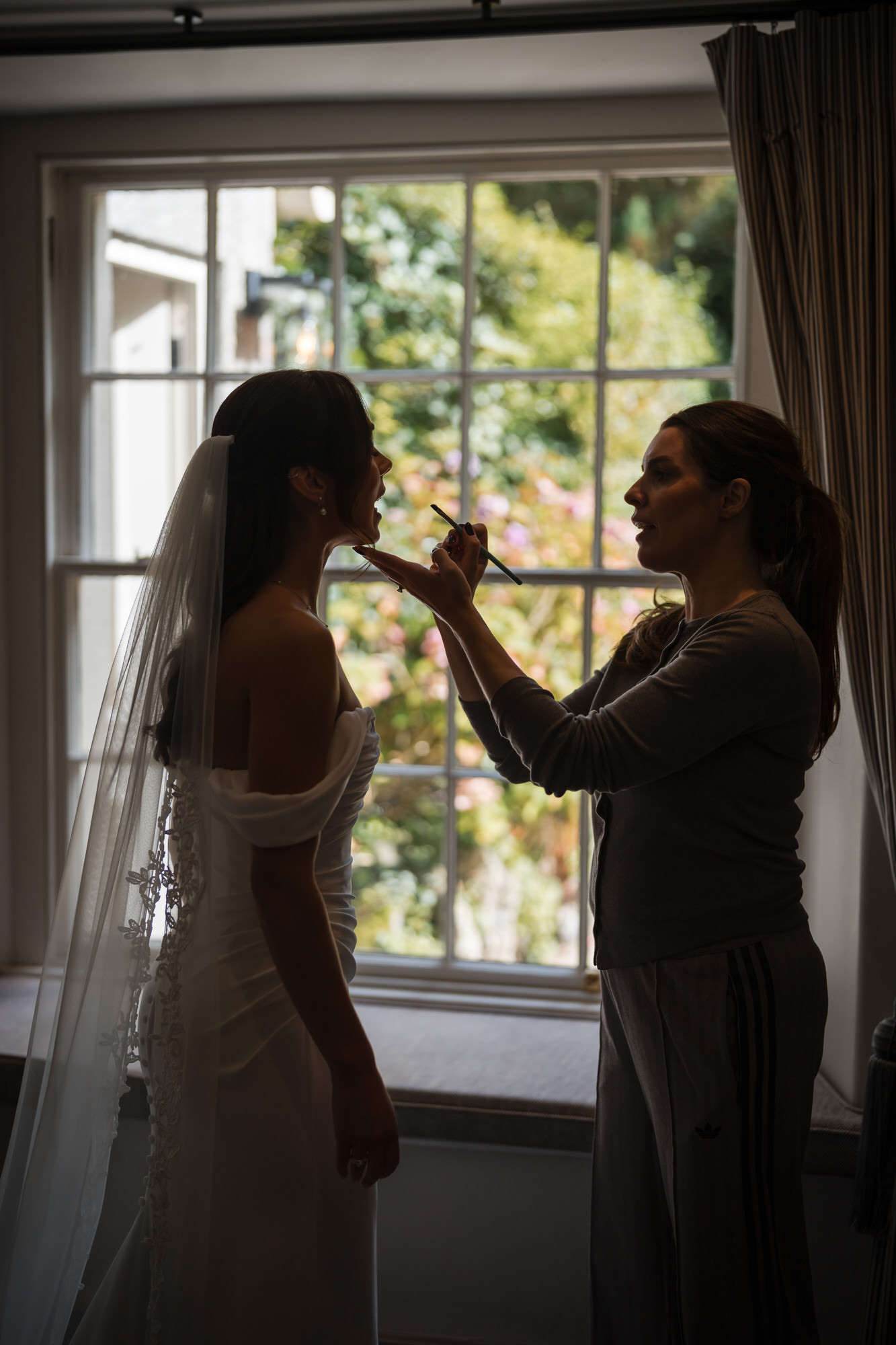 Finishing touches to Ellie’s make-up beside the window