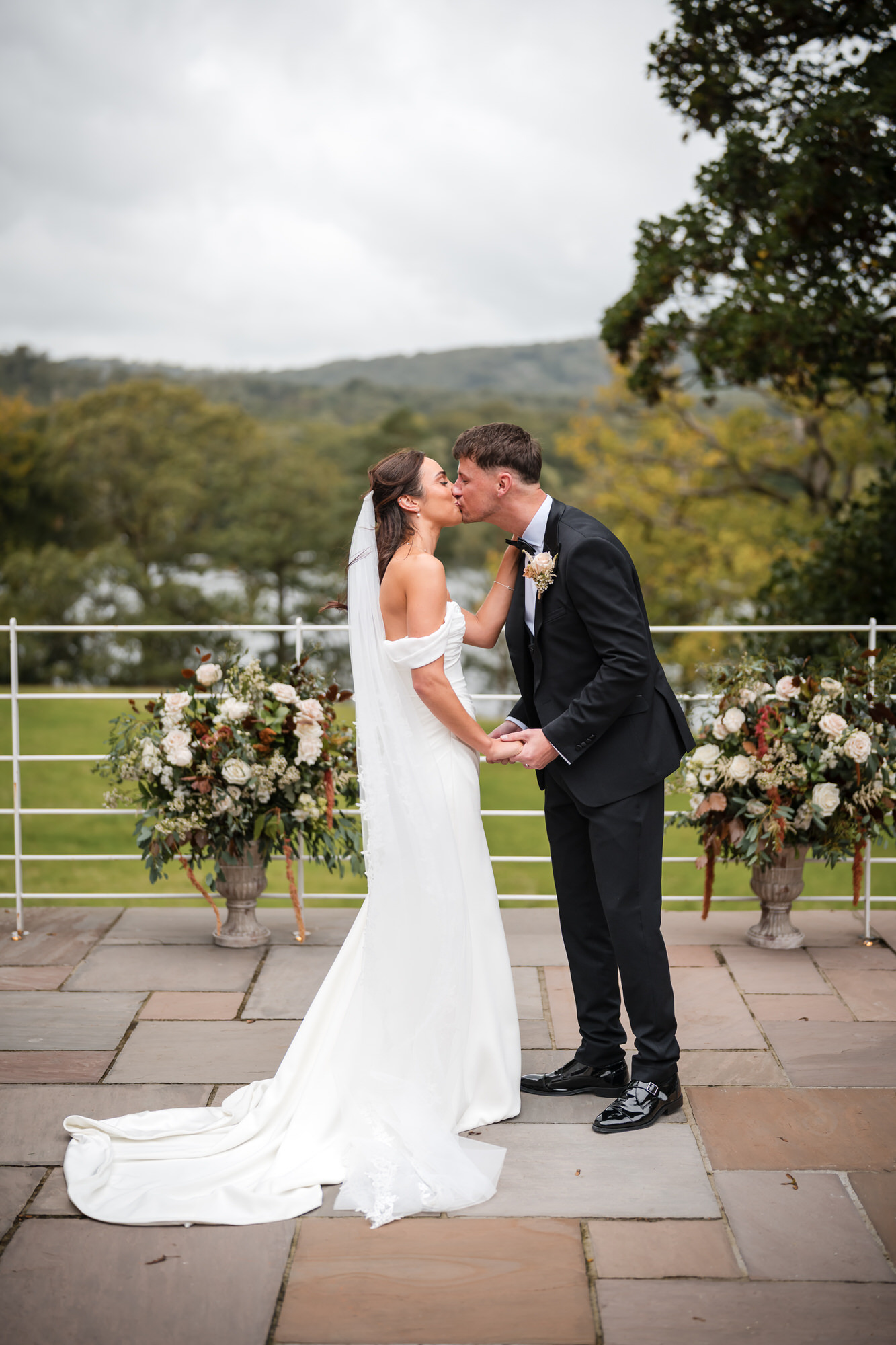 Dan and Ellie sharing a kiss during their outdoor ceremony