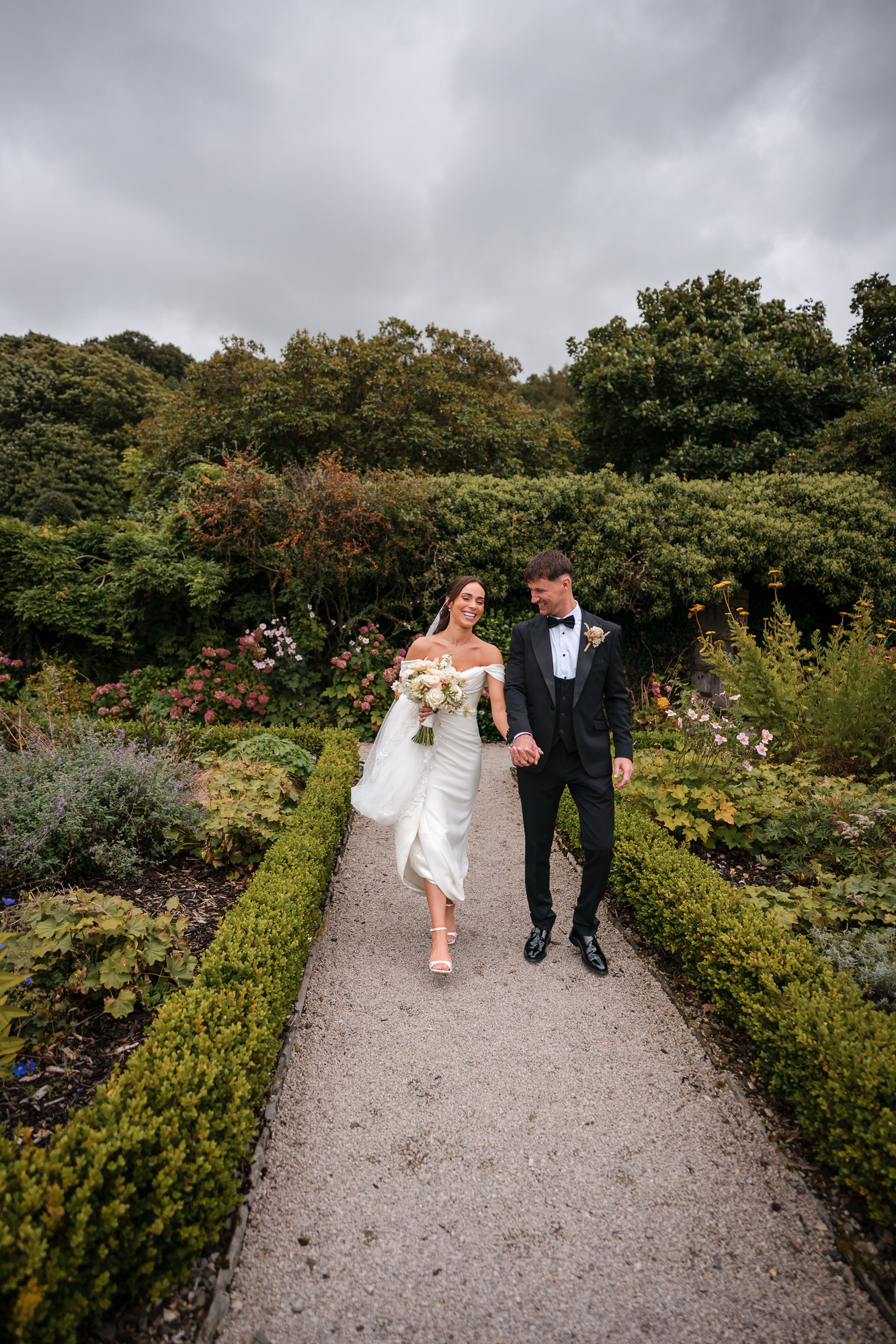 Dan and Ellie walking along a garden path at Town Head Estate