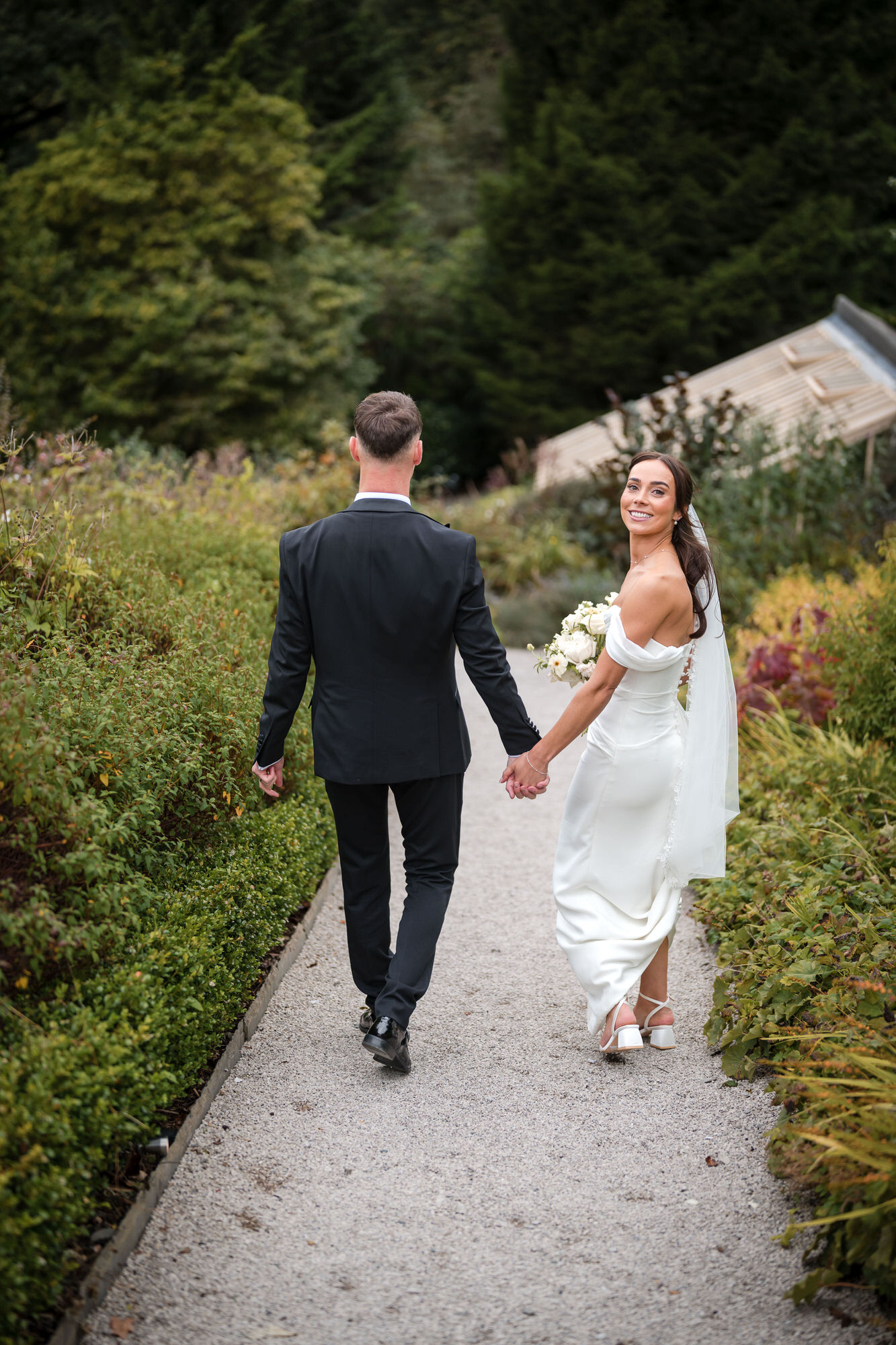 Ellie looking back while walking hand in hand with Dan