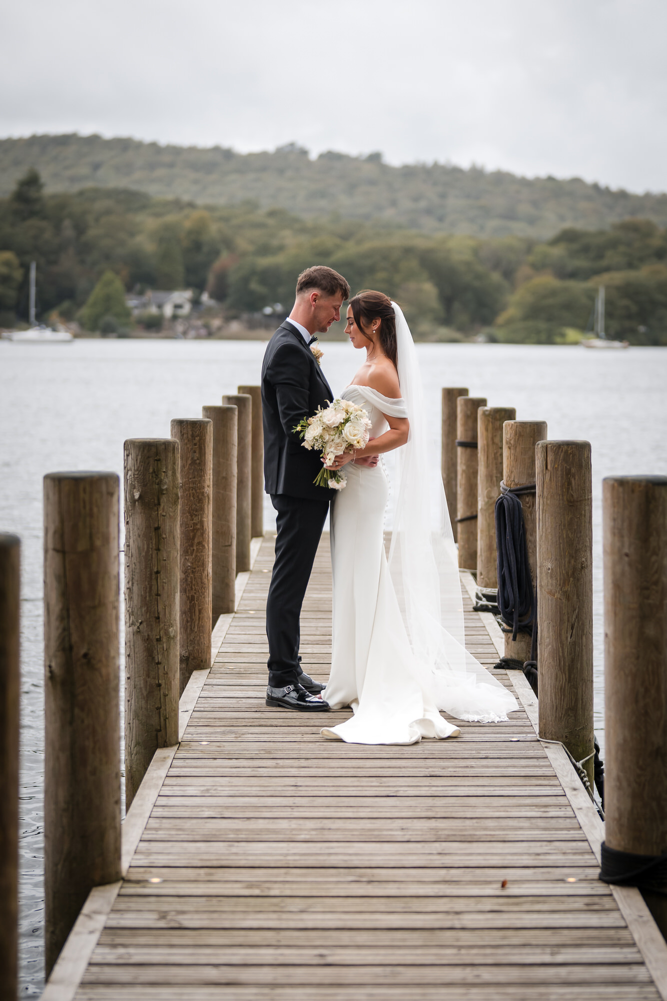 Dan and Ellie embracing at the end of the wooden jetty on Windermere