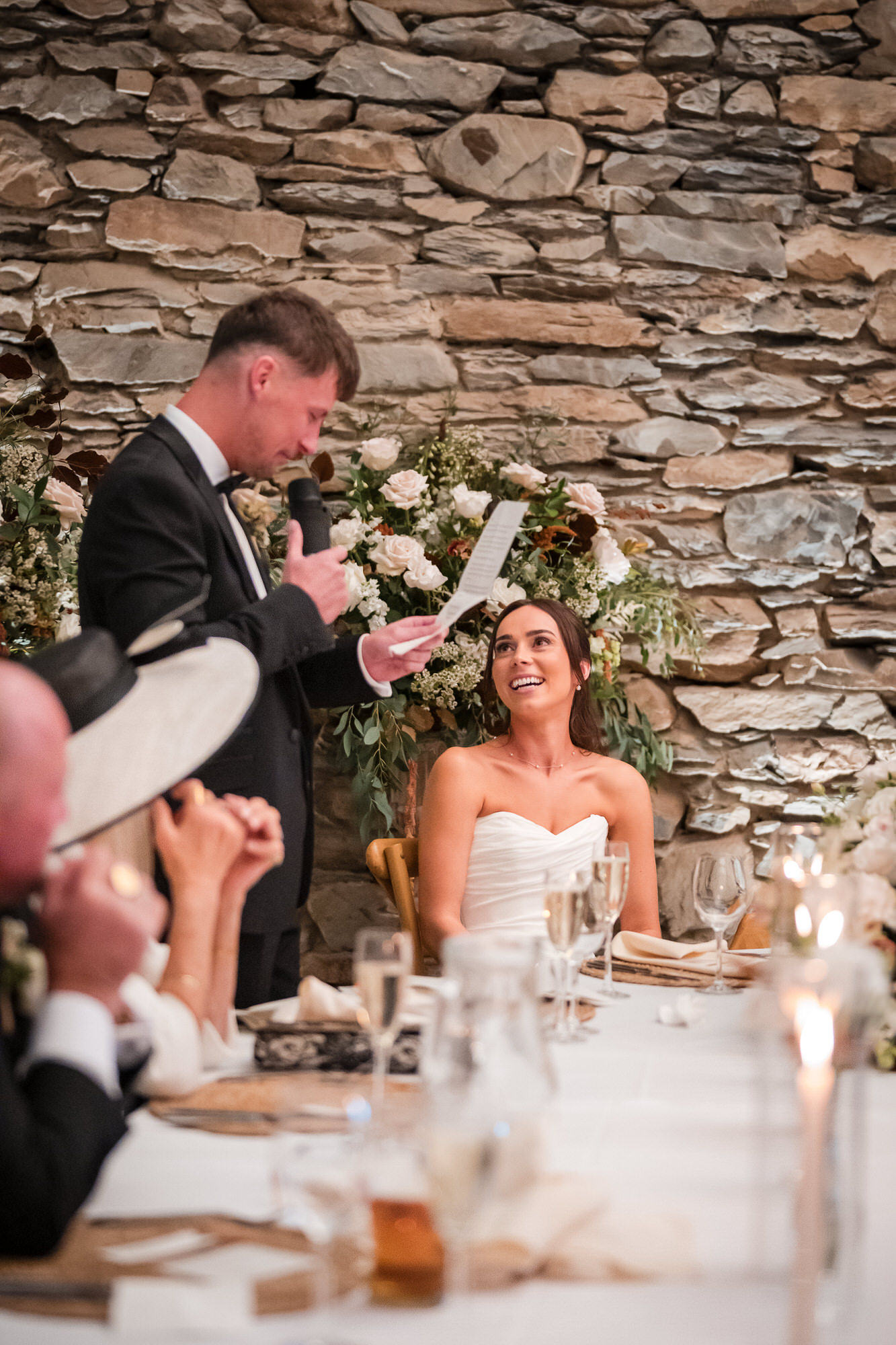 Dan speaking beside Ellie at the wedding reception