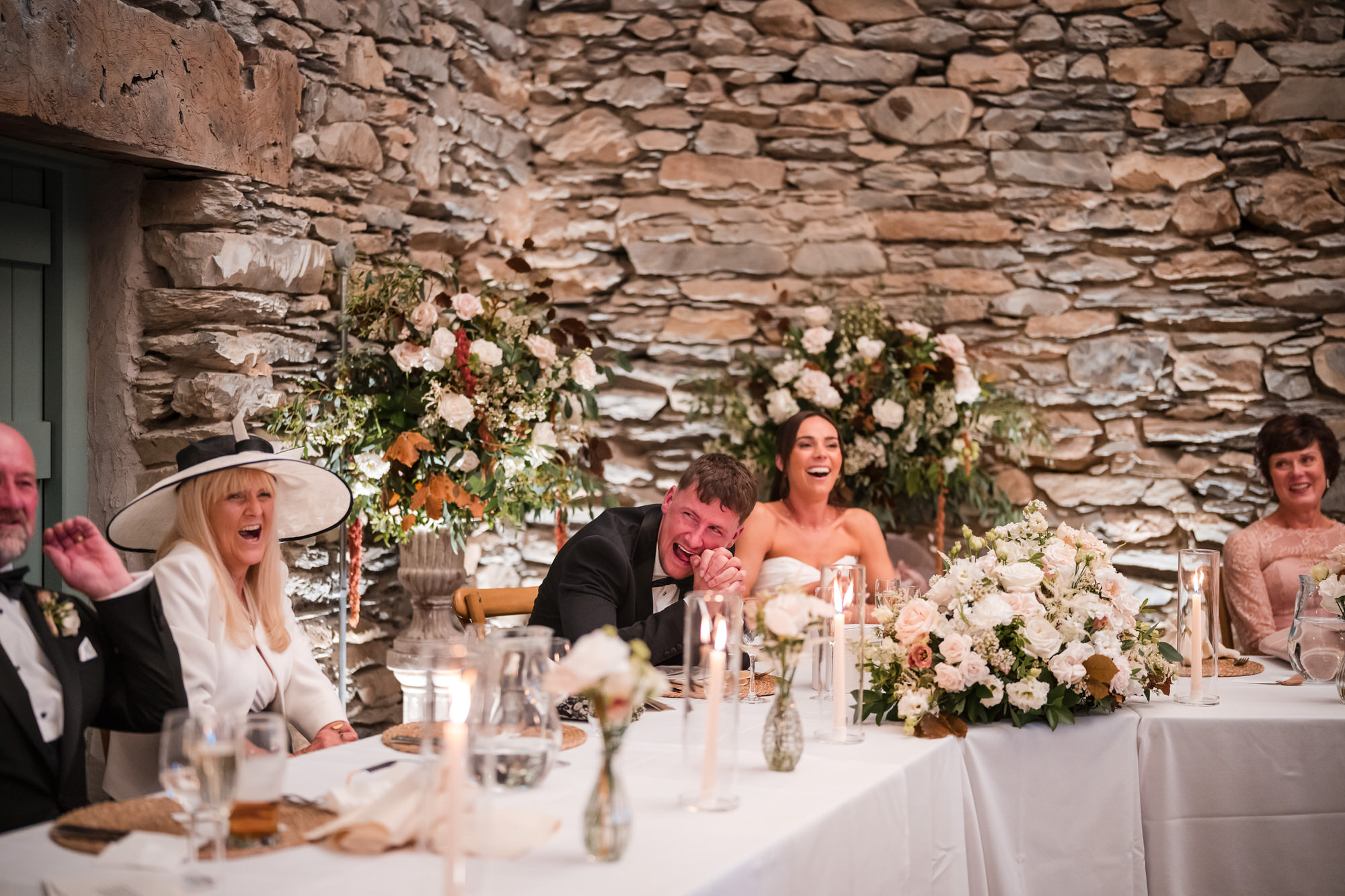 Ellie laughing with family at the top table during the speeches