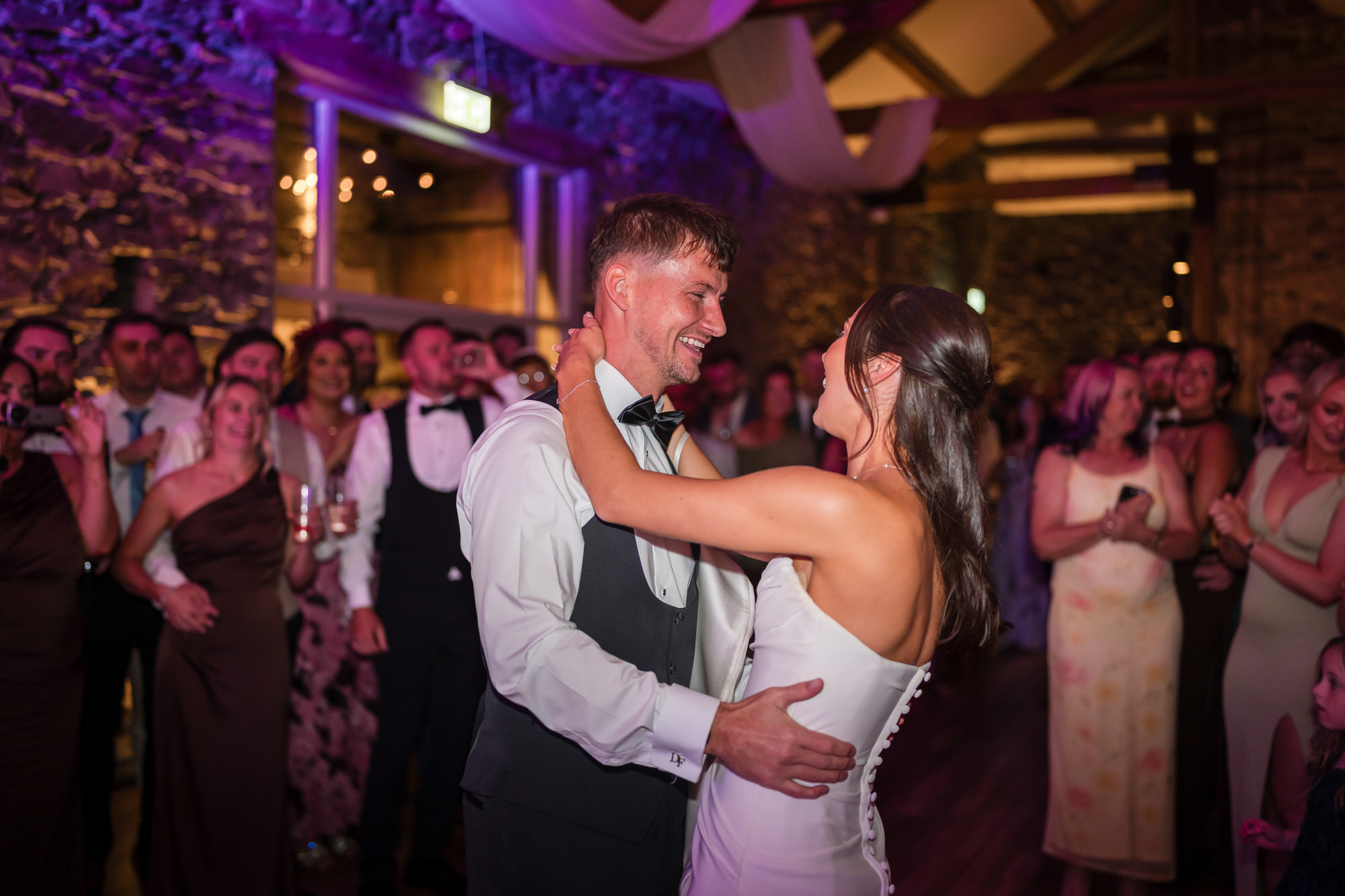 Dan and Ellie smiling at one another during their first dance