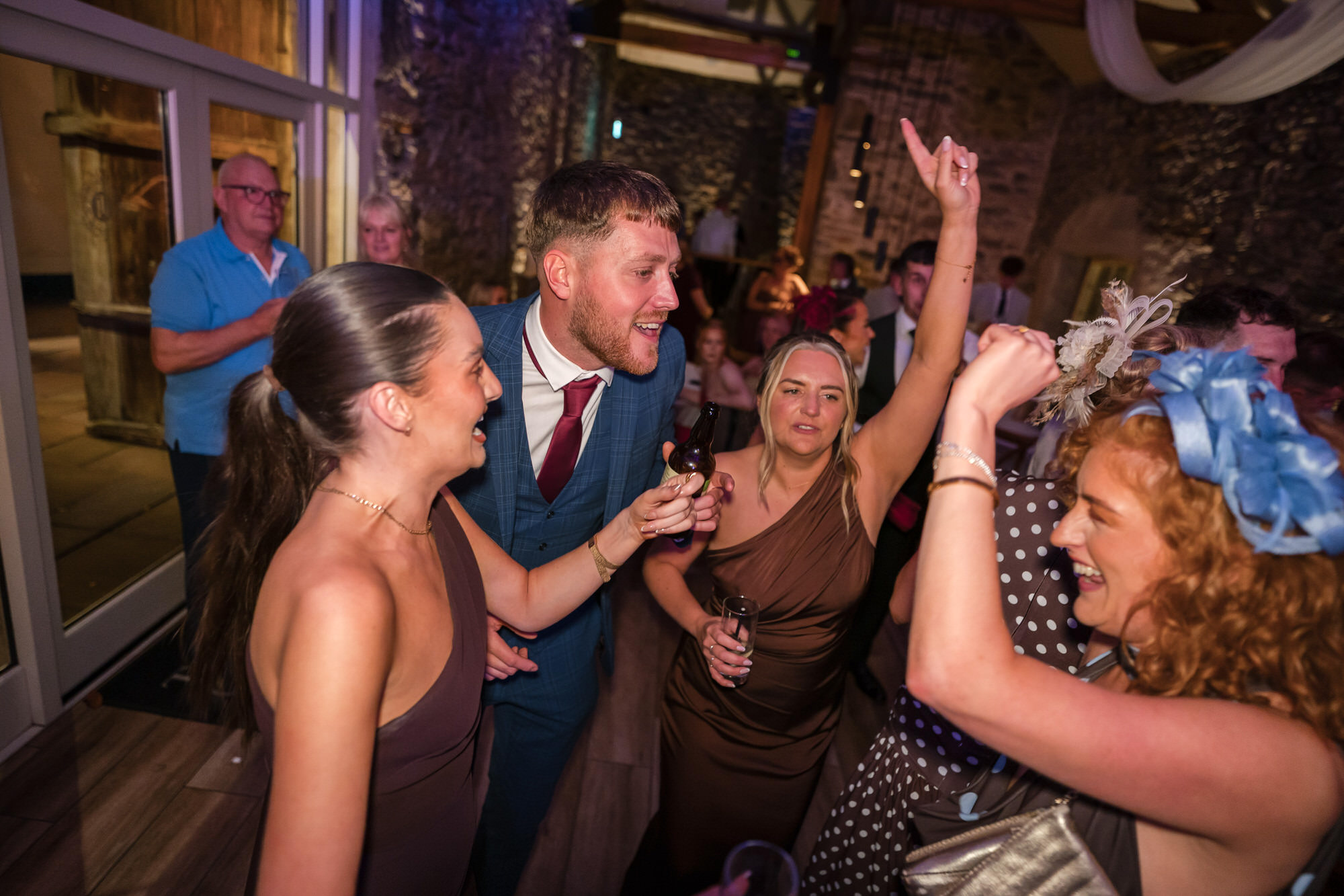 Dan and Ellie celebrating with friends on the dance floor