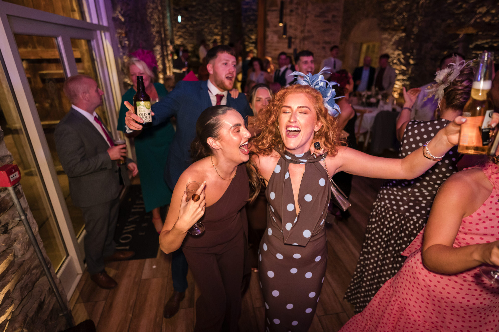 Ellie laughing and dancing with friends at the evening party